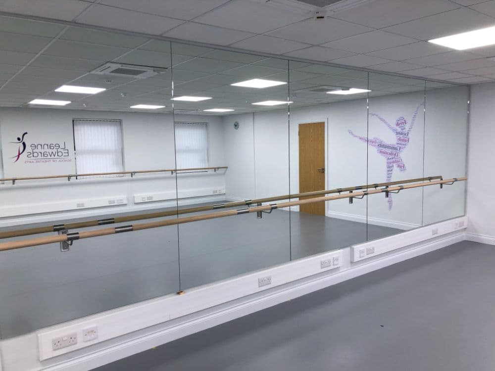 Fonteyn studio at LESTA, Knaphill, with barre, mirrors and the school logo on the wall